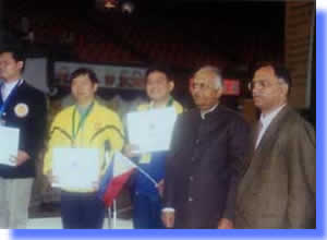 Mr. Ervin Reyes (middle) pose receiving the Certificate of Achievement.