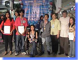 NCWDP Director Catalina Fermin and TESDA Director Washingston Agustin pose together with together with winners of English Desktop Publishing Category.