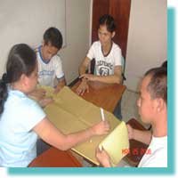 Elma writting in manila paper while her group are thinking about the Accessibility 