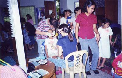 Picture taking during dental examination at STAC center.