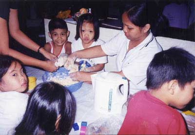 Parents helps OT patients for a group therapy activities.